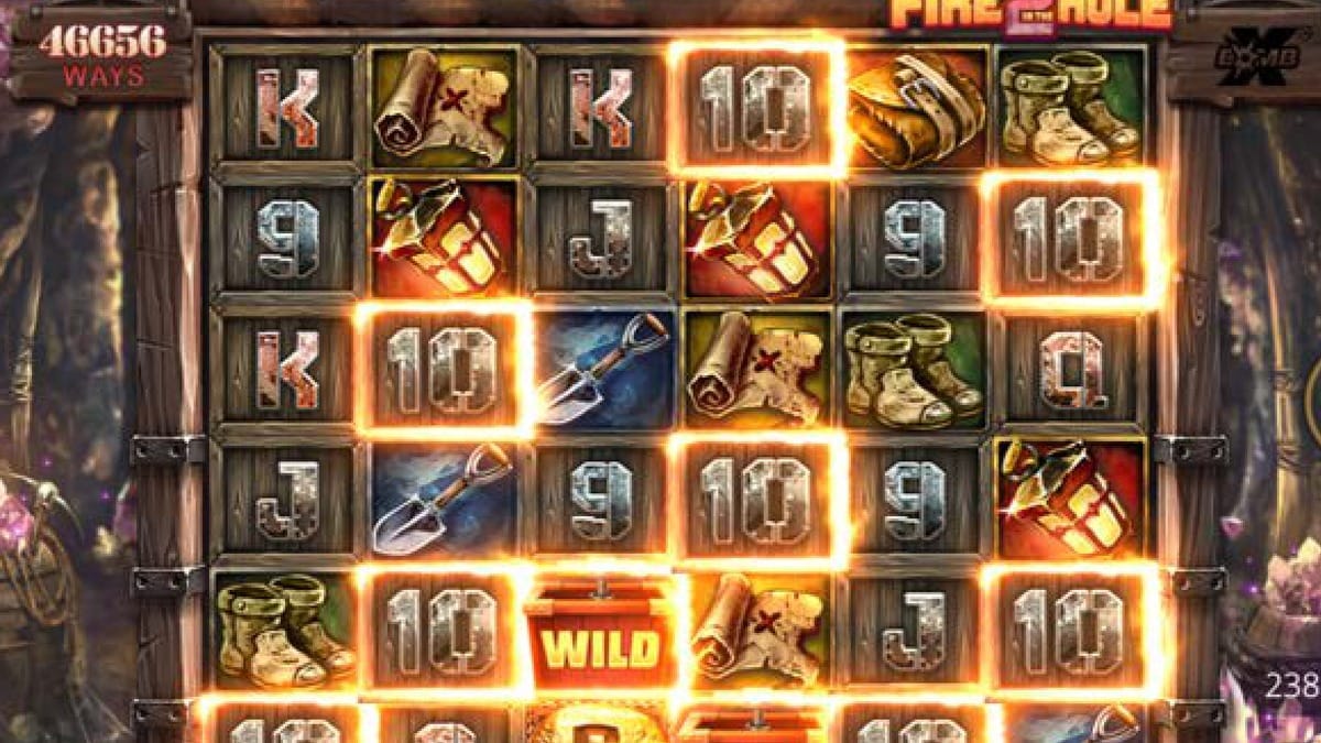 Grade do Fire In The Hole 2 com 4096 ways ativa, xBomb Wild explodindo com luz azul e simbolos de mineracao. Nolimit City.